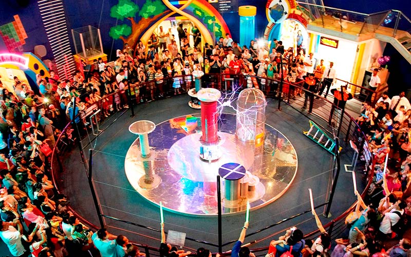  school children and teachers gathering around a tesla induction coil