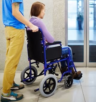 Worker at get museum pushing an wheel chair visitor.